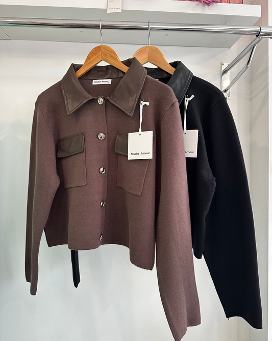 Brown jacket with a tag on a hanger against a white background